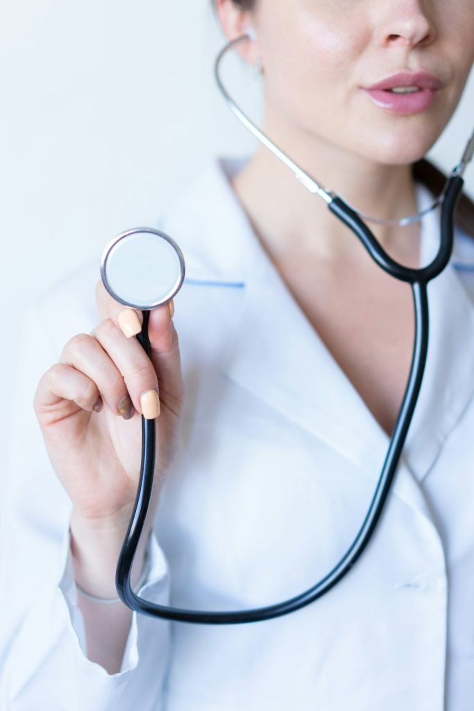 a-woman-in-a-white-shirt-holding-a-stethoscope-te7-jvk-yu a-woman-in-a-white-shirt-holding-a-stethoscope-te7-jvk-yu